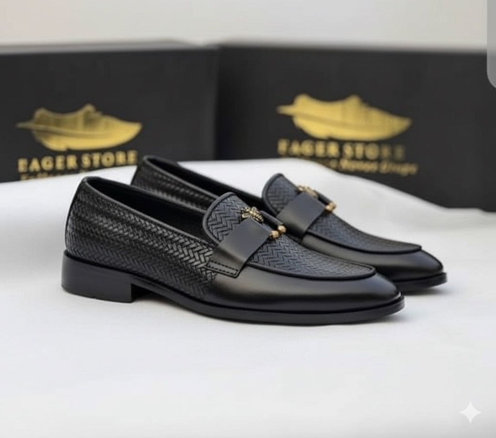 Black textured loafers with the signature bee accent.